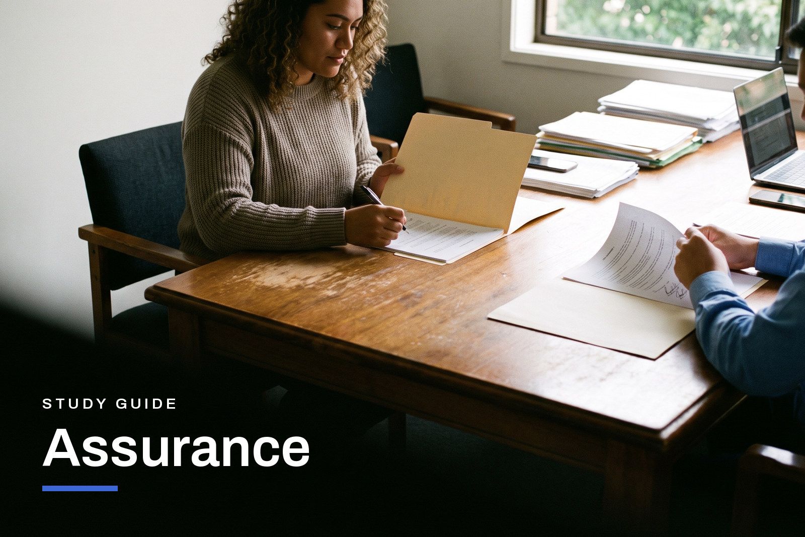 Assurance study guide header, an audit senior and a colleague working through a file of evidence at a client's boardroom table in an Australian office.