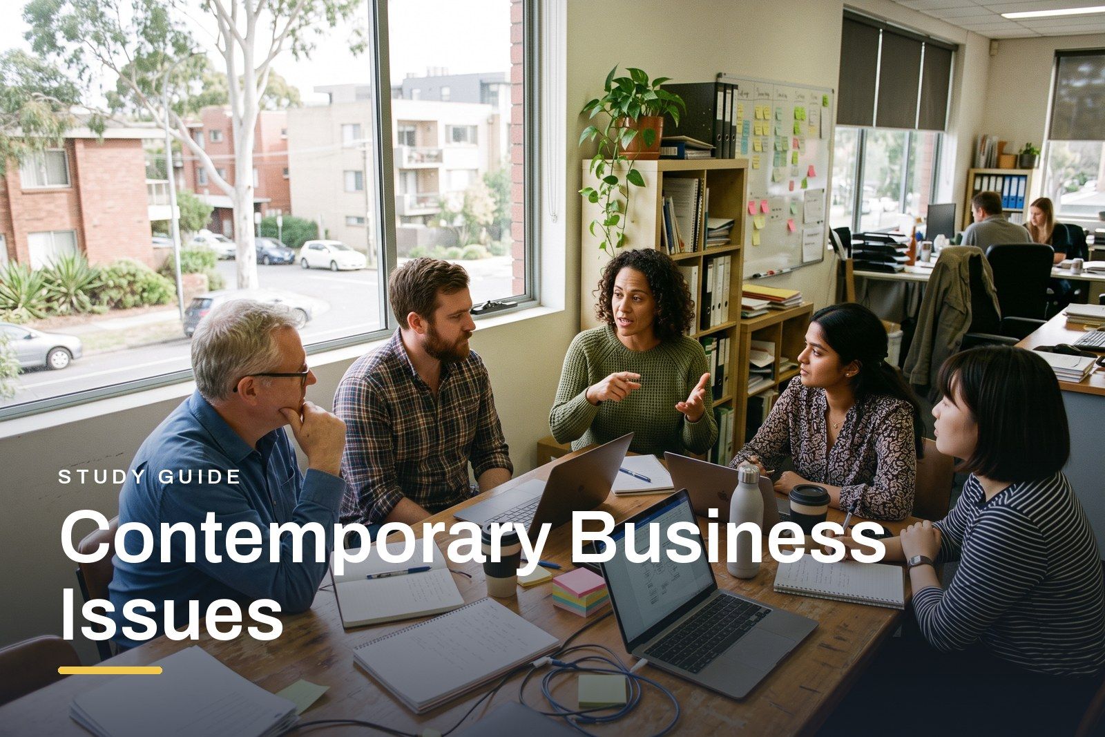 Contemporary Business Issues study guide header, a small diverse team in a bright Australian office discussing business trends around a table, laptops and notes in front of them.